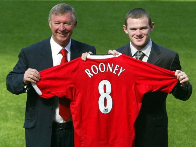 Sir Alex Ferguson and Wayne Rooney pose with the latter's shirt at his Manchester United unveiling.