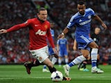 Wayne Rooney and Ashley Cole battle for possession.