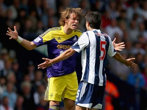 Miguel Michu of Swansea clashes with Claudio Yacob of West Brom during the Barclays Premier League match between West Bromwich Albion and Swansea City at The Hawthorns on September 01, 2013