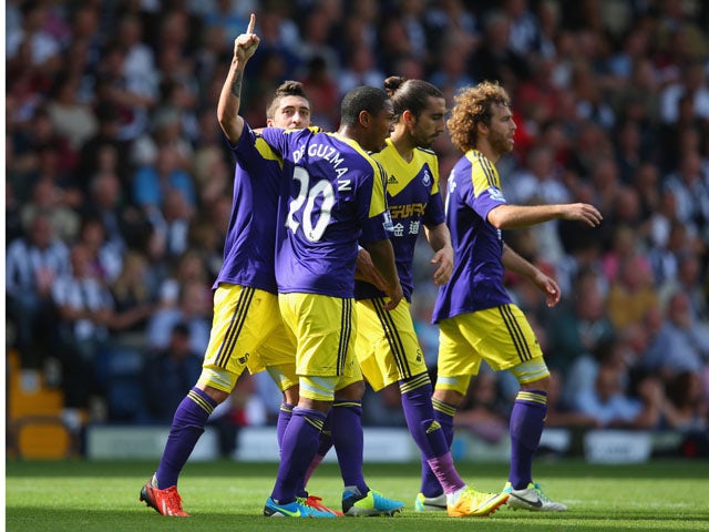 Pablo Hernandez of Swansea celebrates with team mates after scoring their second goal during the Barclays Premier League match between West Bromwich Albion and Swansea City at The Hawthorns on September 01, 2013