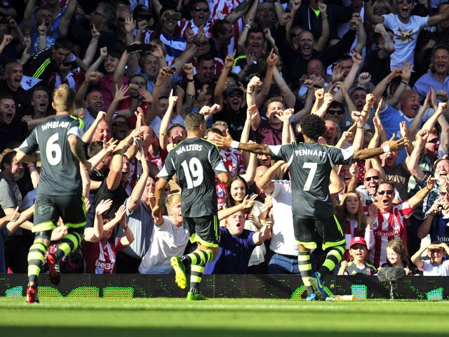 Stoke City's English midfielder Jermaine Pennant celebrates scoring his goal with supporters during the English Premier League football match against West Ham United at the Boleyn Ground, Upton Park, in East London, England, on August 31, 2013
