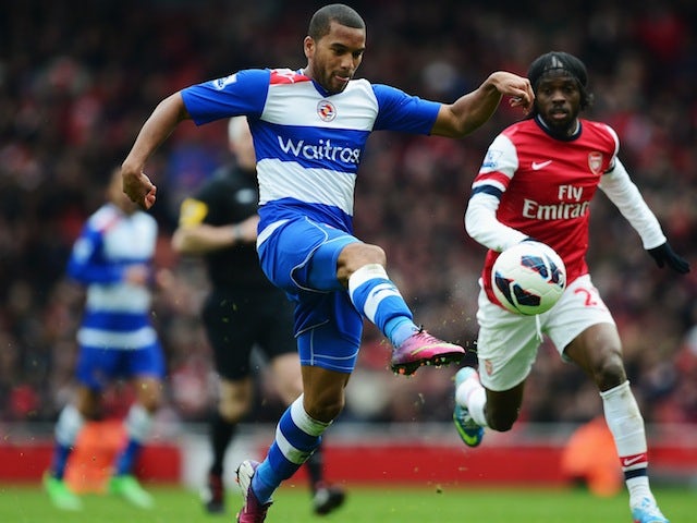 Adrian Mariappa of Reading gets to the ball ahead of Arsenal's Gervinho during a Premier League match on March 30, 2013