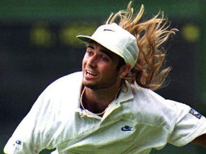 Andre Agassi serves the ball to Andrei Cherkosov at Wimbledon on June 25, 1992