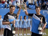 US brothers Bob and Mike Bryan pose with the trophy after winning the ATP Aegon Championships final doubles tennis match against French pair, Michael Llodra and Nicolas Mahut, at the Queen's Club in west London on June 16, 2013