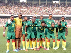 Cameroon's national team lines up before a game with DR Congo on June 16, 2013