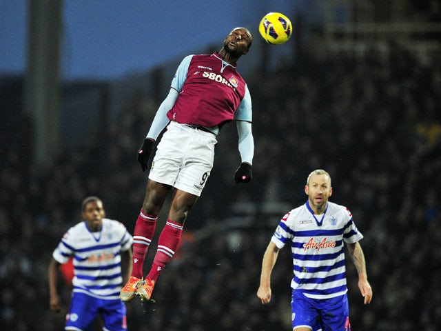 West Ham United's English striker Carlton Cole heads the ball during the English Premier League football match between West Ham United and Queens Park Rangers at the Boleyn Ground, Upton Park, in East London, England, on January 19, 2012