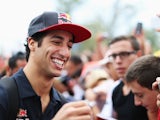 Daniel Ricciardo signs autographs for fans at the paddock ahead of the Italian Grand Prix at Monza on September 8, 2013