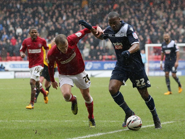 Chris Solly of Charlton Athletic tries to tackle Dany N'Guessan of Millwall during the npower Championship match between Charlton Athletic and Millwall at The Valley on March 16, 2013