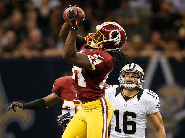 DeJon Gomes #24 of the Washington Redskins intercepts a ball over Lance Moore #16 of the New Orleans Saints during the season opener at Mercedes-Benz Superdome on September 9, 2012