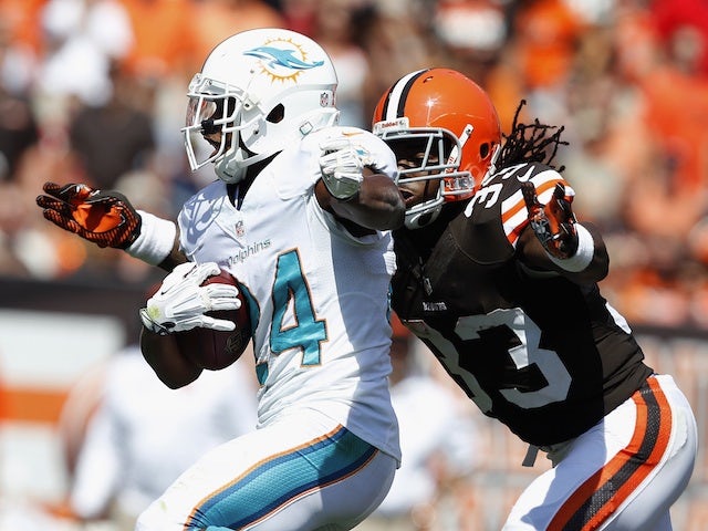 Miami's Dimitri Patterson fends off Trent Richardson of Cleveland during a game on September 8, 2013