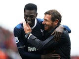 Spurs forward Emmanuel Adebayor smiles with coach Andre Villas-Boas after a win over Stoke on May 12, 2013