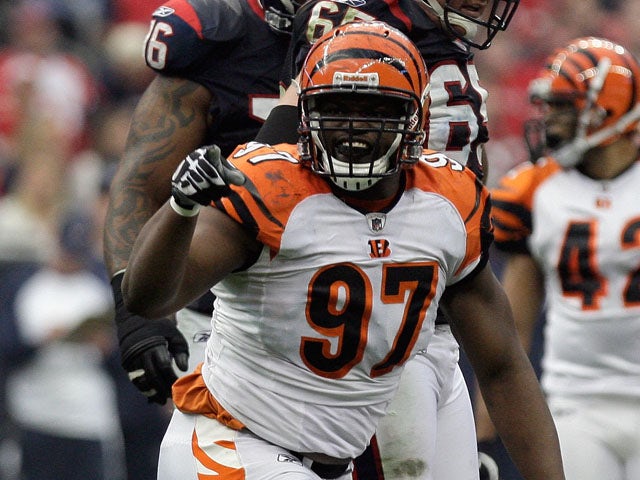 Geno Atkins #97 of the Cincinnati Bengals celebrates after he sacked T.J. Yates #13 of the Houston Texans in the first half during their 2012 AFC Wild Card Playoff game at Reliant Stadium on January 7, 2012