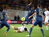 France's midfielder Moussa Sissoko is tackled by Georgia's midfielder Tornike Okriachvili during the FIFA World Cup 2014 qualifying football match Georgia vs France on September 6 2013
