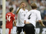 Germany's striker Thomas Mueller and Germany's defender Benedikt Hoewedes celebrate after the third goal for Germany during the FIFA World Cup 2014 group C qualifying football match of Germany vs Austria on September 6, 2013