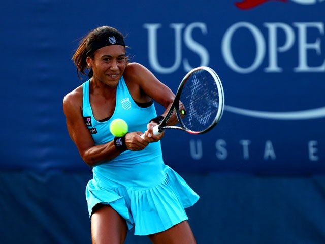 Heather Watson of Great Britain returns a shot to Simona Halep of Romania during their women's singles first round match on Day Two of the 2013 US Open at USTA Billie Jean King National Tennis Center on August 27, 2013