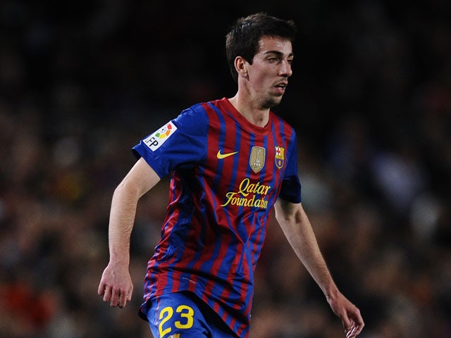 Isaac Cuenca of FC Barcelona runs with the ball during the La Liga match between FC Barcelona and Getafe CF at Camp Nou on April 10, 2012