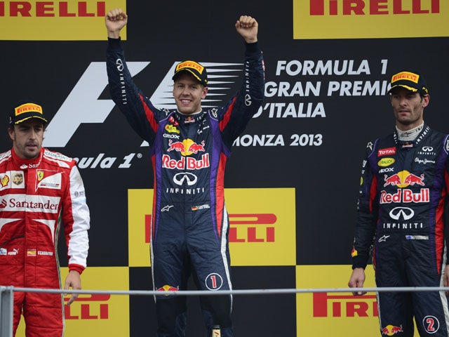 Red Bull Racing's German driver Sebastian Vettel and Red Bull Racing's Australian driver celebrates on the podium at the Autodromo Nazionale circuit in Monza on September 8, 2013