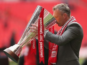 Crewe Alexandra manager Steve Davis celebrates with the Johnstone's Paint Trophy after winning the competition on April 7, 2013