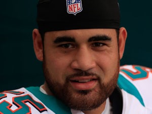 Koa Misi #55 of the Miami Dolphins standa in the tunnel prior to the game against Oakland Raiders at Sun Life Stadium on September 16, 2012