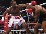 Lennox Lewis attempts to land a punch on Mike Tyson during their World Heavyweight Championship bout on June 8, 2002