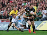 George North of Northampton Saints breaks through the Exeter Chiefs' defence during the Aviva Premiership match between Northampton Saints and Exeter Chiefs at Franklin's Gardens on September 7, 2013