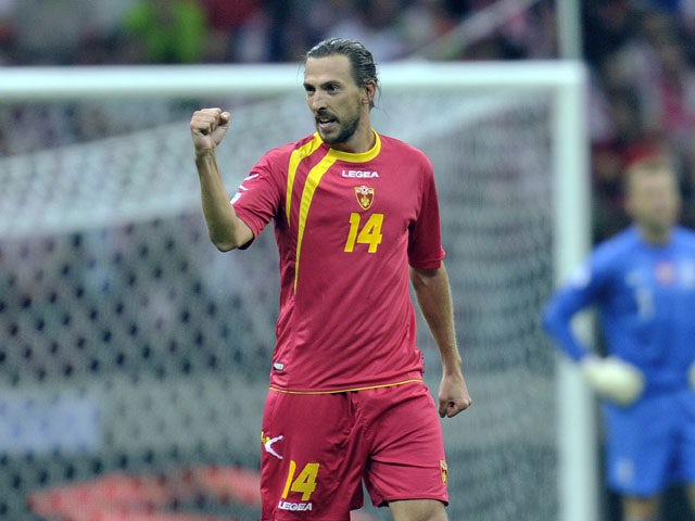 Montenegro's Dejan Demjanovic celebrates after scoring during the FIFA 2014 World Cup Qualifier between Poland and Montenegro at the National Stadium on September 06, 2013