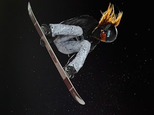 Shaun White soars high above the pipe as he wins gold in the men's snowboard superpipe final during Winter X Games on January 29, 2012