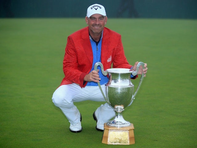 Thomas Bjorn poses with the Omega European Masters trophy after beating Craig Lee in a playoff to win the tournament for a second time on September 8, 2013
