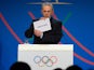 International Olympic Committee (IOC) President Jacques Rogge shows the name of the city of Tokyo elected to host the 2020 Summer Olympics during a session of the IOC in Buenos Aires, on September 7, 2013