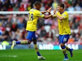 Arsenal's Aaron Ramsey celebrates with team mate Kieran Gibbs after scoring his team's second goal against Sunderland on September 14, 2013