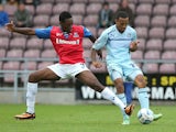 Gillingham's Amine Linganzi and Coventry's Callum Wilson in action during their League One match on September 15, 2013