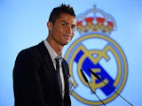 Real Madrid's Cristiano Ronaldo smiles after signing a new contract at the Bernabeu on September 15, 2013