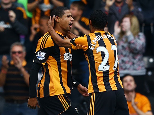 Hull's Curtis Davies is congratulated by team mate Ahmed Elmohamady after scoring the opening goal against Cardiff on September 14, 2013