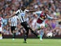 Villa's Fabian Delph and Newcastle's Mapou Yanga-Mbiwa battle for the ball on September 14, 2013