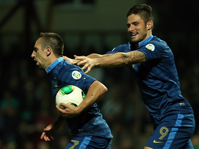 France's Franck Ribery is congratulated by team mate Olivier Giroud after scoring the opening goal against Belarus during their World Cup qualifier on September 10, 2013