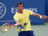 Ivan Dodig of Croatia returns a forehand to Lleyton Hewitt of Australia during the BB&T Atlanta Open in Atlantic Station on July 26, 2013