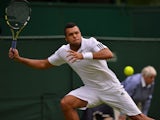France's Jo-Wilfried Tsonga returns against Latvia's Ernests Gulbis in their second round men's singles match on day three of the 2013 Wimbledon Championships tennis tournament at the All England Club in Wimbledon, southwest London, on June 26, 2013