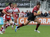 Saracens' Joel Tomkins races clear to score his team's first try during the match against Gloucester on September 15, 2013