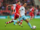 West Ham's Mark Noble and Southampton's Adam Lallana battle for the ball during their Premier League match on September 15, 2013