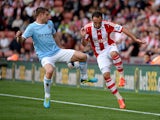 Stoke's Matthew Etherington and Manchester City's James Milner battle for the ball on September 14, 2013