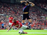 Manchester United's Patrice Evra and Crystal Palace's Mile Jedinak battle for the ball during their Premier League match on September 14, 2013
