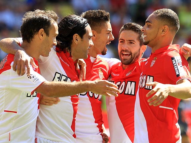 Monaco's Radamel Falcao is congratulated by team mates after scoring the opening goal from the penalty spot during the match against FC Lorient on September 15, 2013