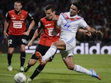 Rennes' Romain Danze vies with Lyon's French midfielder Clement Grenier during the match on September 15, 2013