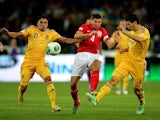 Ukraine's Edmar and Taras Stepanenko battle for the ball with England's Steven Gerrard during their World Cup qualifying match on September 10, 2013