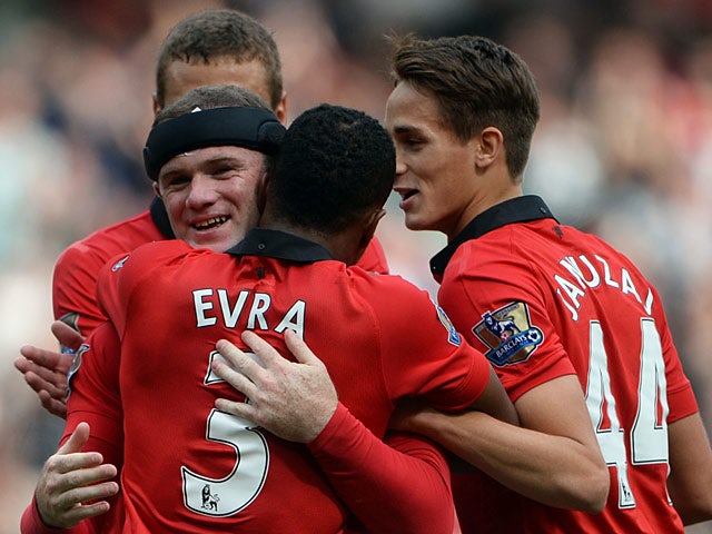 Manchester United's Wayne Rooney is congratulated by team mates after scoring his team's second goal against Crystal Palace on September 14, 2013