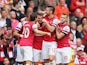 Arsenal's Aaron Ramsey is congratulated by teammates after scoring the opening goal against Stoke during their Premier League match on September 22, 2013