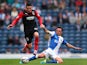 Huddersfield Town's Adam Hamill and Blackburn's Corry Evans battle for the ball during their Championship match on September 21, 2013