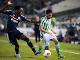 Lyon's Bakary Kone and Betis' Chuli battle for the ball during their Europa League group match on September 19, 2013
