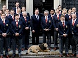 Prime Minister David Cameron poses with the British and Irish Lions rugby squad, with Manu Tuilagi making a gesture behind the PM on September 16, 2013
