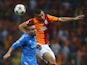 Galatasaray's Burak Yilmaz jumps for a header over Real defender Daniel Carvajal on September 17, 2013